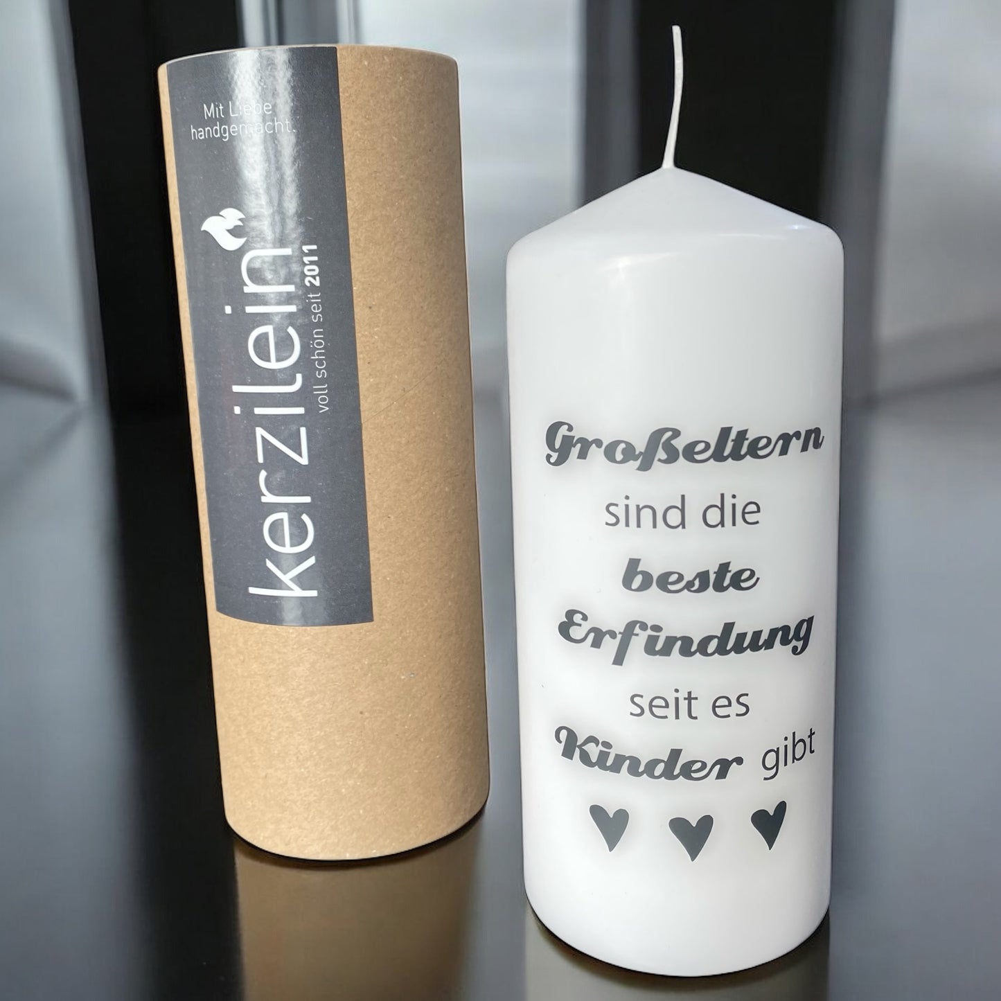 Stumpenkerze mit Spruch „Großeltern sind die beste Erfindung seit es Kinder gibt“ im Ambiente