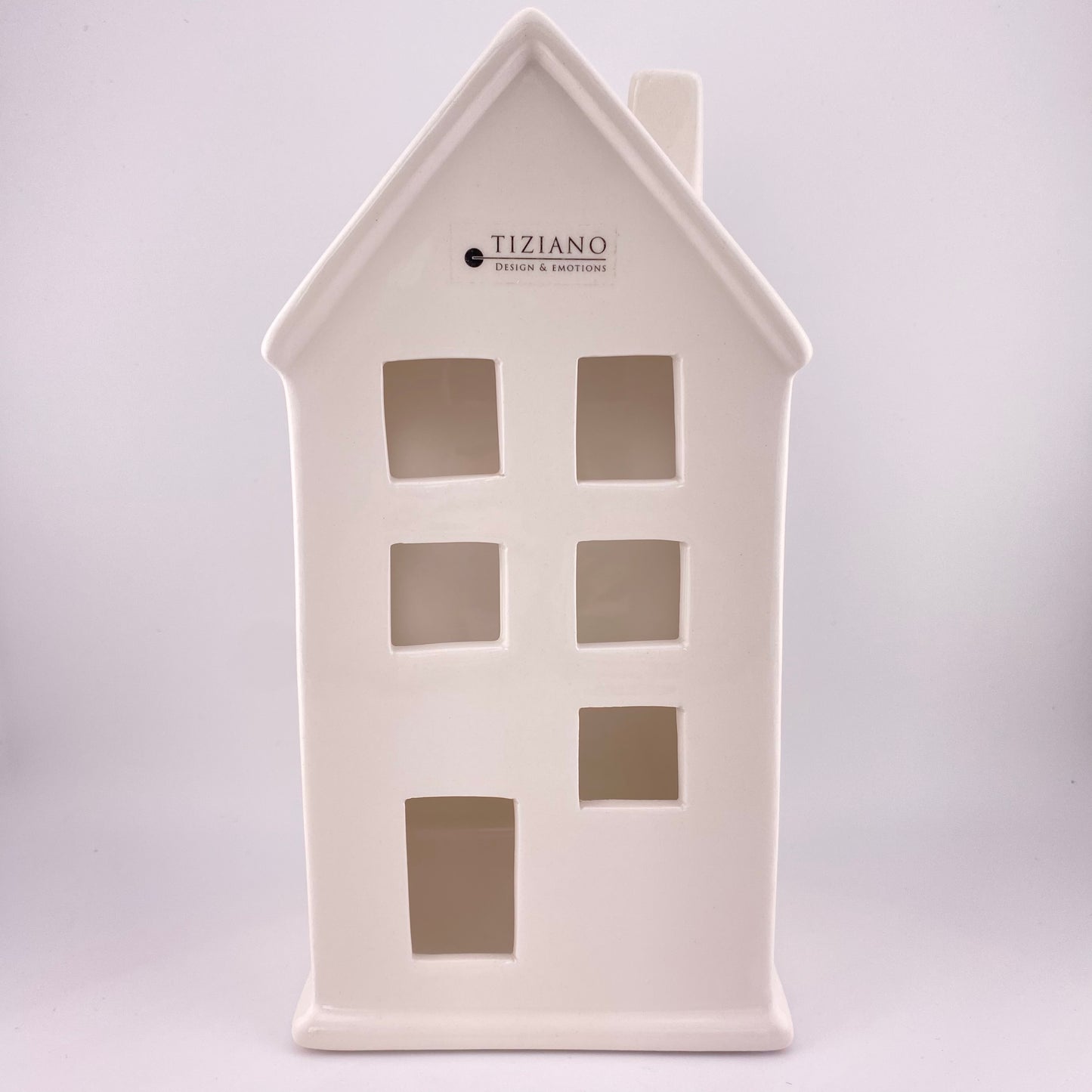 Ein großes Keramik Deko Haus mit großen Fenstern, Türen und Schornstein aus creme-weißer Keramik gefertigt. Vor weißem Hintergrund platziert und 23cm groß.