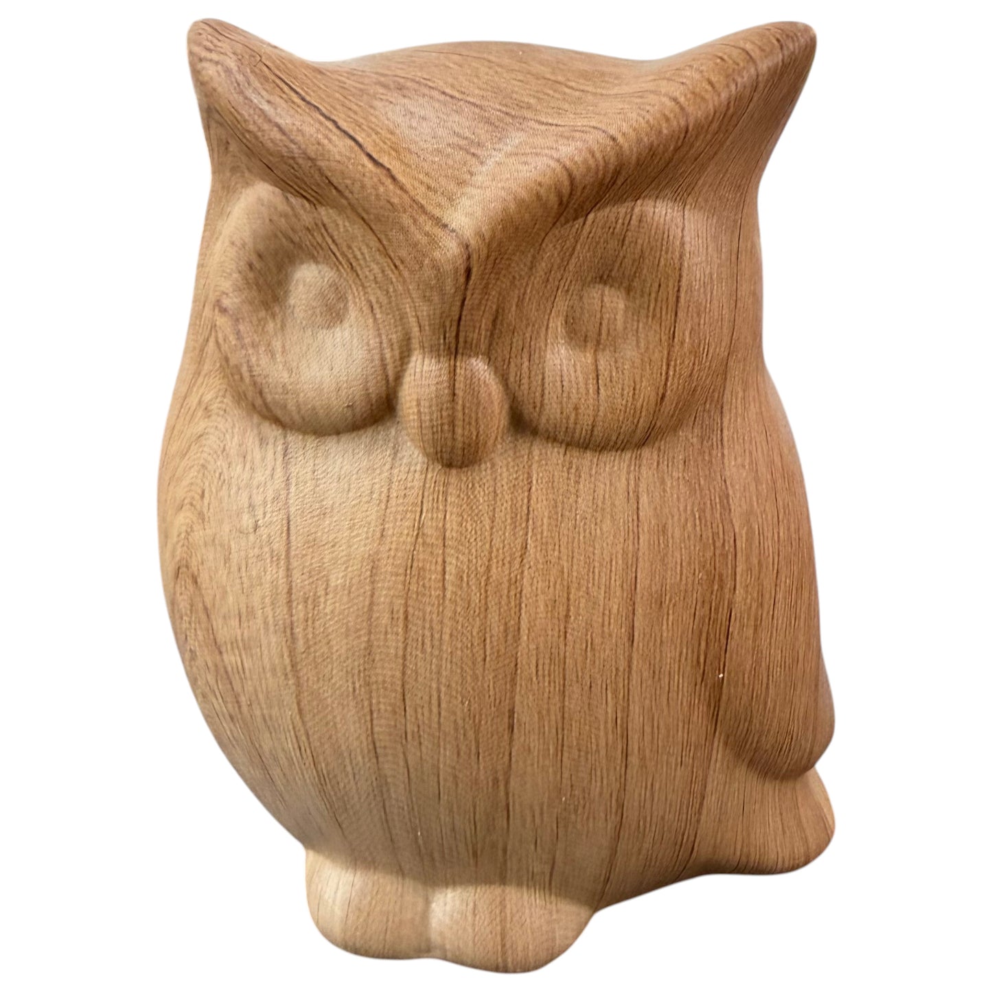 Eine Eulenfigur mit sichtbarer Holzmaserung zeigt ein schlichtes, abgerundetes Design mit angedeuteten Augen und Flügeln.