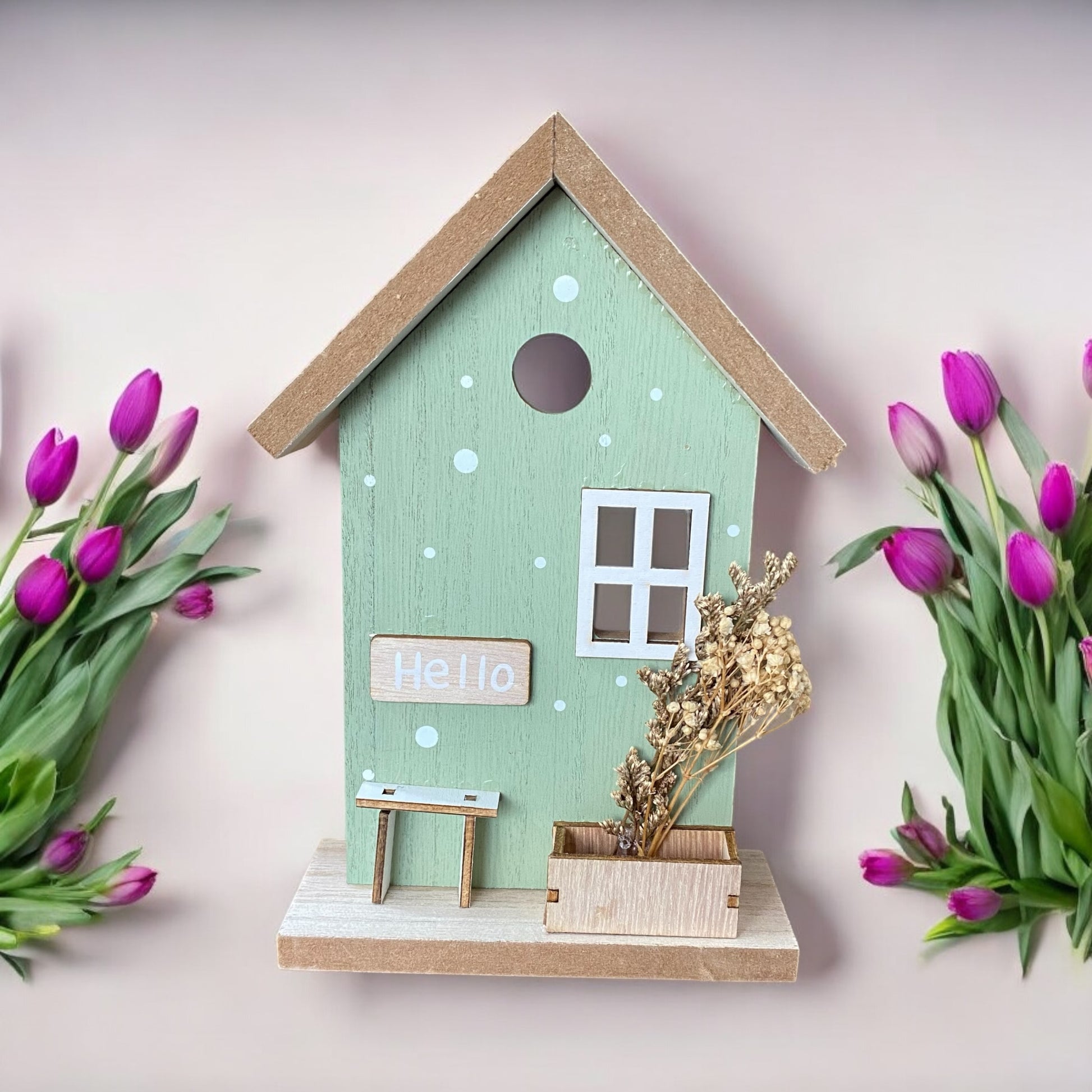 Aufsteller Haus aus Holz in Mint mit Deko-Elementen wie Fahrrad und Trockenblumen im Ambiente