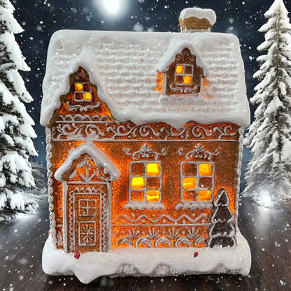 Breites Formano Lebkuchenhaus mit LED-Beleuchtung, leuchtend im verschneiten Wald arrangiert.