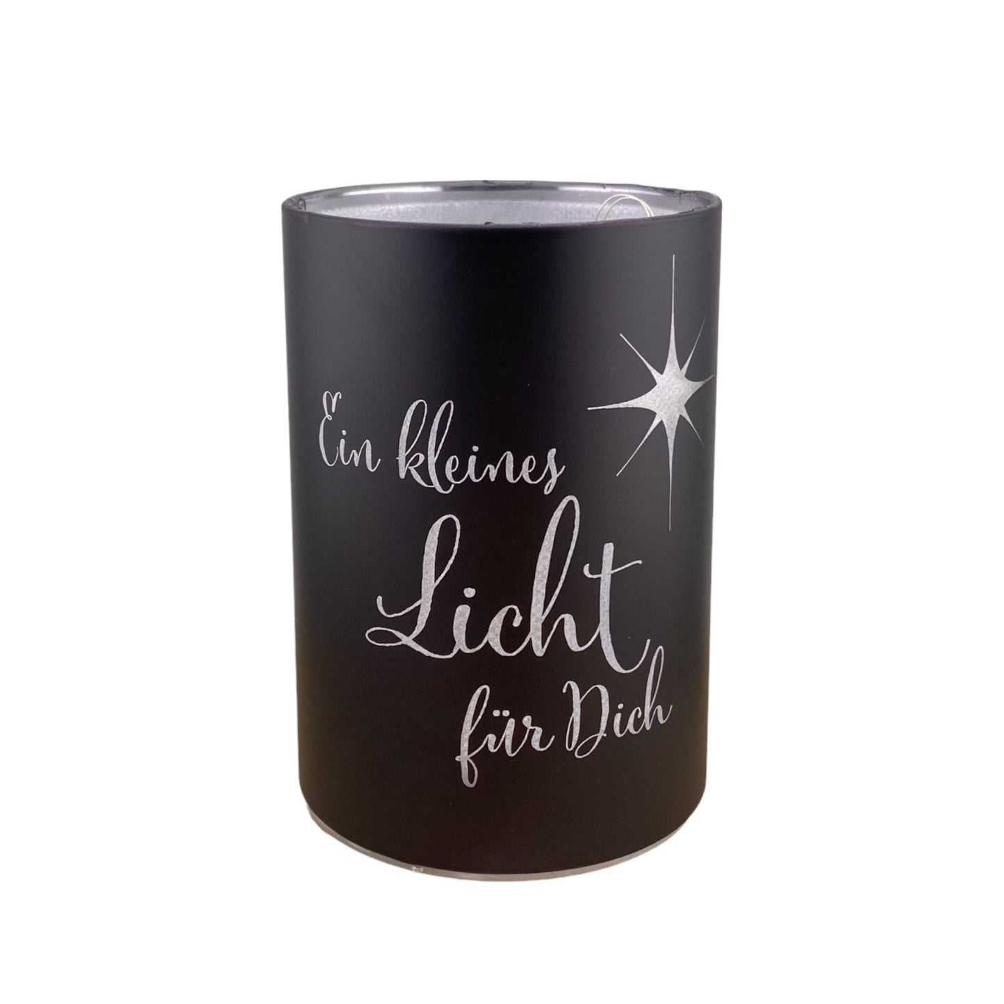 Eine schwarze LED Dekolicht Säule mit Spruch "Ein kleines Licht für Dich!" und kleinem Stern ist 10 cm groß und vor weißem Hintergrund platziert.