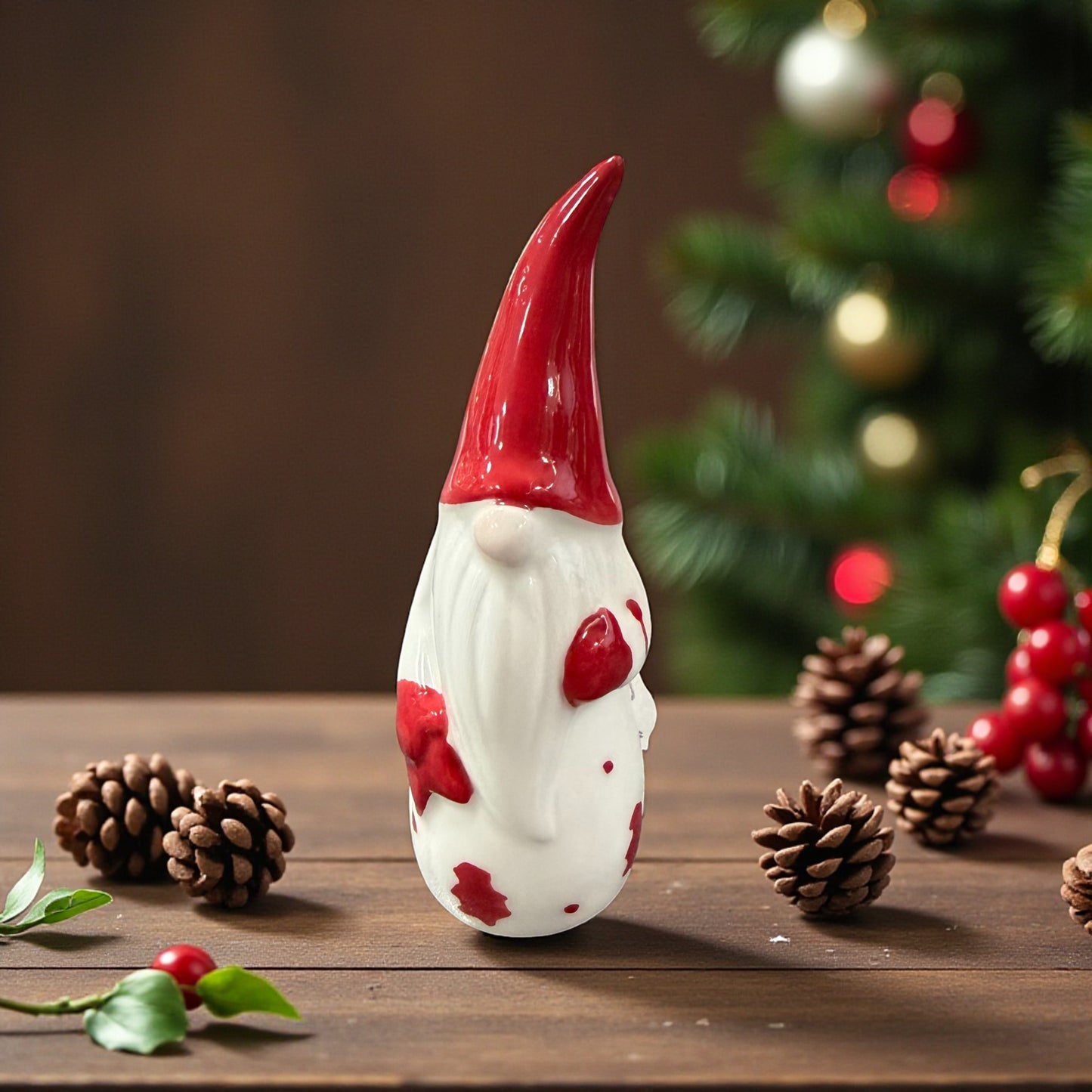 Ein kleiner Keramik-Wichtel mit roter Mütze wird in gemütlicher Weihnachtsatmosphäre präsentiert.