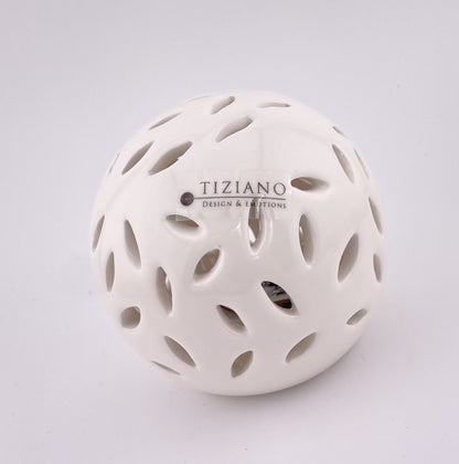 Eine kleine Dekokugel aus creme-weißer Keramik, die von innen mit einem LED Licht beleuchtet werden kann. Sie hat ovalförmige Aussparungen. Die Kugel 8cm groß und vor weißem Hintergrund platziert.